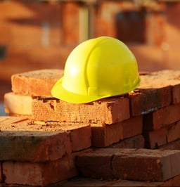 Under construction, helmet and bricks for building site-1 Under construction, helmet and bricks for building site-1